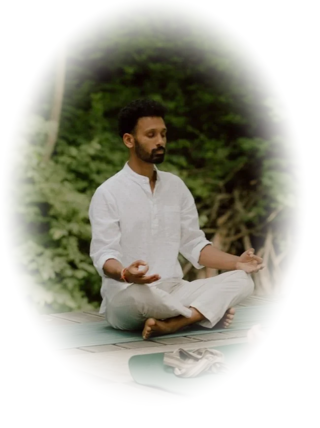 Naveen meditating outdoors in the forest