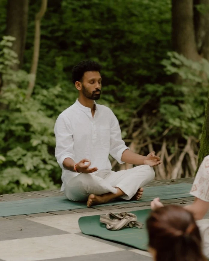 Naveen leading a meditation outdoors in the forest